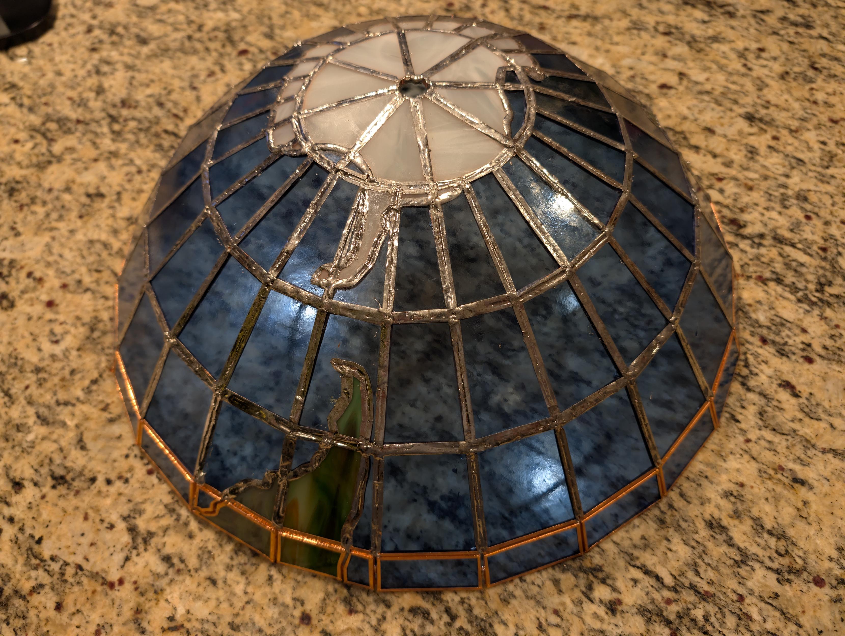 A stained glass globe, from the Tropic of Capricorn down to the south pole, partially soldered.